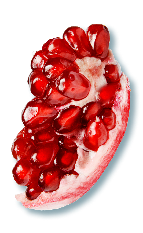 Pomegranate broken in pieces, revealing the deep red seeds inside